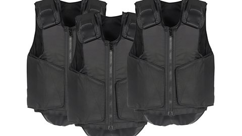 Three black bulletproof vests on a white background.