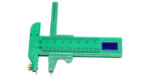 A green compass cutter on a white background.