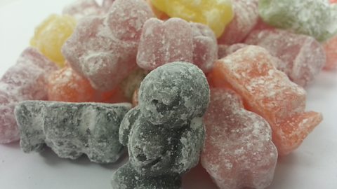 A close-up photograph of coloured jelly babies