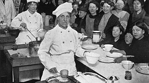 Workers in a National Kitchen serving food to people during World War One