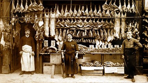 A photograph of three butchers outside their shop front in World War One