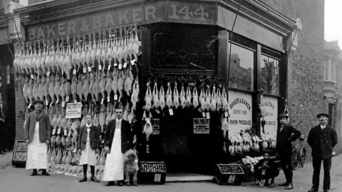 A photograph of five poulterers outside their shop front in World War One