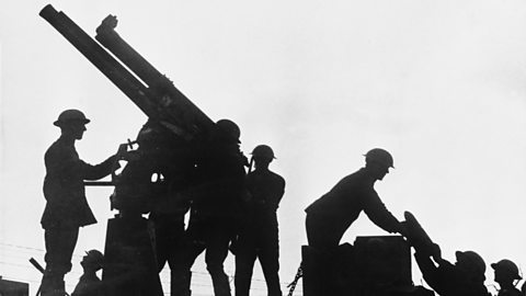 Silhouette of soldiers firing an anti-aircraft gun mounted on a lorry in the Battle of Broodseinde, Flanders