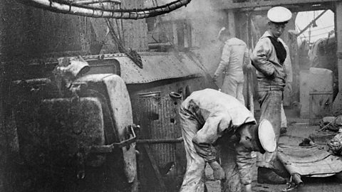 Sailors cleaning the deck of a ship during World War One