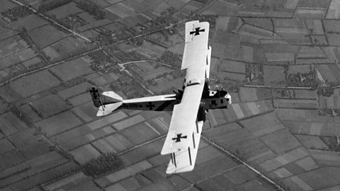 A German Gotha bomber flying over fields during World War One