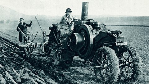 A farmer and his wife at work on a specially built tractor in the early 1900s