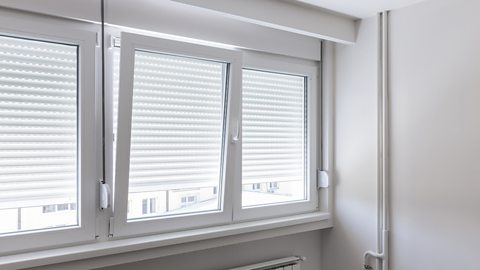 A white polyvinyl chloride (PVC) window frame in a modern and bright living room.