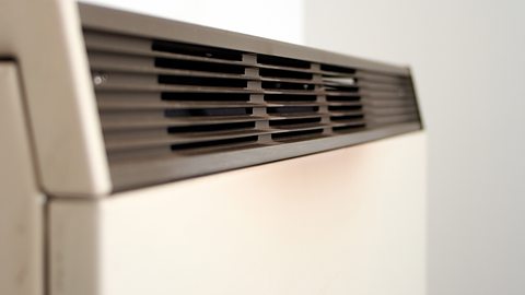 An old-type electric storage heater with a vent to release heat.