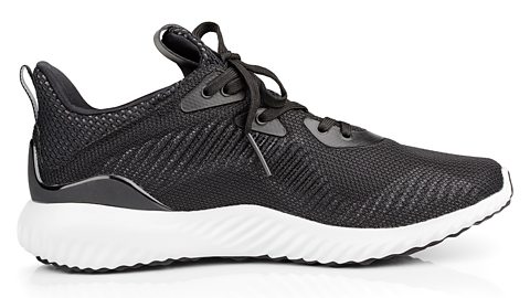 A single, new and unbranded black sport running shoe.