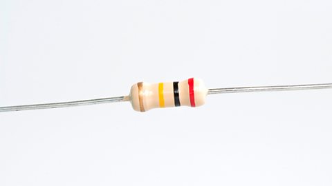 A resistor with four bands (brown, yellow, black and red) against a white background.