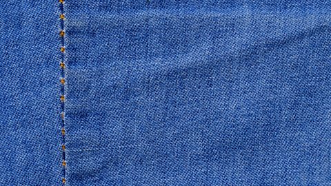 A plain seam shown joining to pieces of dark blue denim.