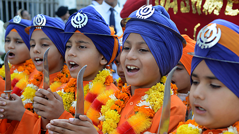 These Indian Sikhs are dressed as Panj Pyare. They are marching in a procession celebrating one of the Sikh Guru's birthday.