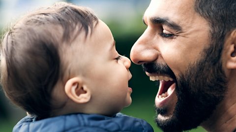 A dad laughing with his son