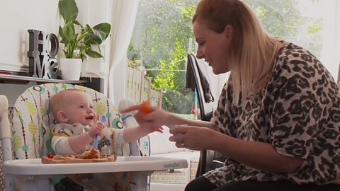 Alison talking to Austin in his highchair.