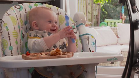 Austin having messy fun at mealtime.