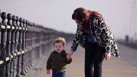 Elizabeth and Percy walking by the sea.