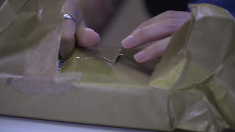 Mum opening parcel for baby