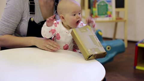 Baby playing with wrapped parcel