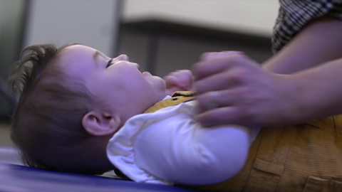 Baby lying on the floor dancing