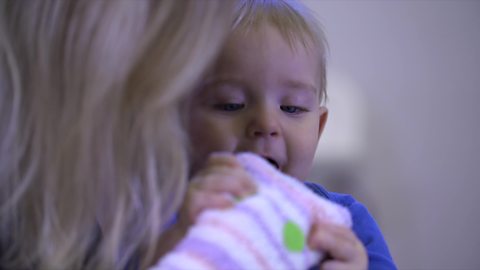 Baby playing with a sock puppet