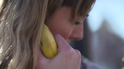 Mum using a banana as a phone