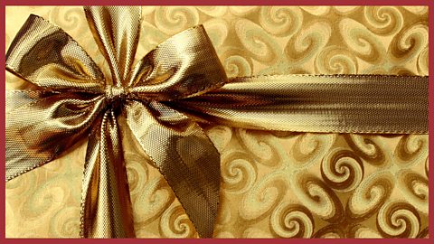 An image of a box wrapped in golden paper.