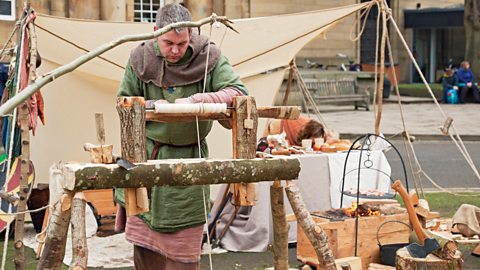 Man using a lathe at a re-enactment of a medieval fayre 