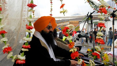 Sikhs celebrating Vaisakhi with music and flower garlands.