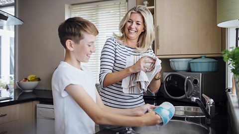 Mum and son washing the dishes