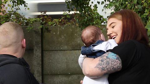 A mum talking to her baby about a passing train.