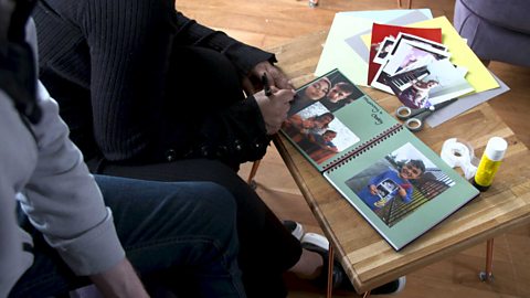 A couple making a scrapbook.