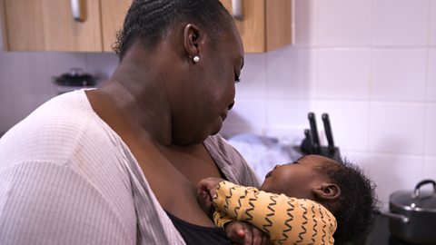 A mum swaying her baby.