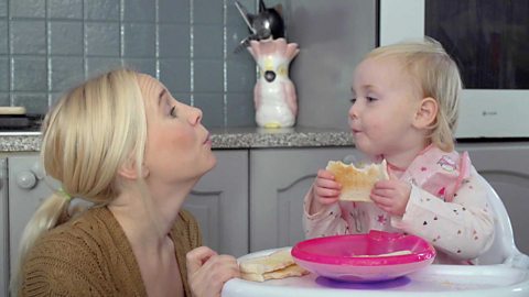 A mum talking to her little girl about the smell of toast.