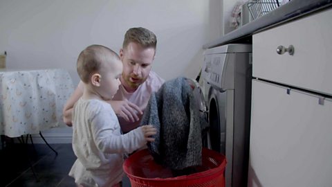 A dad talking about a jumper to his young daughter.