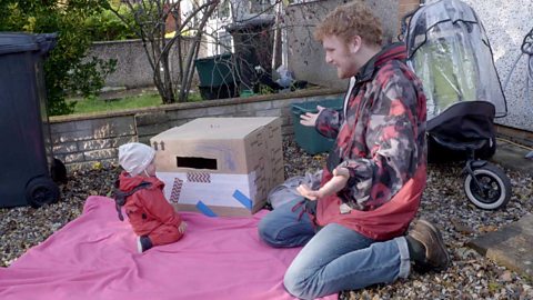 A big brother talking to his little sister about the postbox.