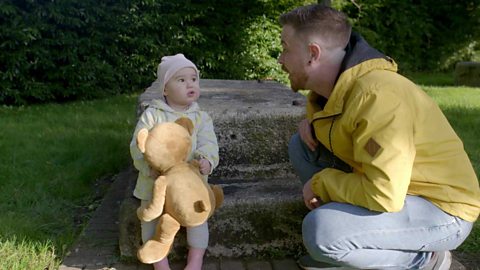 The little girl saying the last word of a rhyme to her dad.