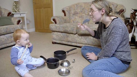 A mum and her son both mining eating with a spoon.