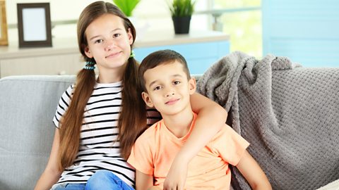 A brother sits with his older sister