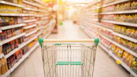 A photo of an empty trolley in a supermarket aisle.