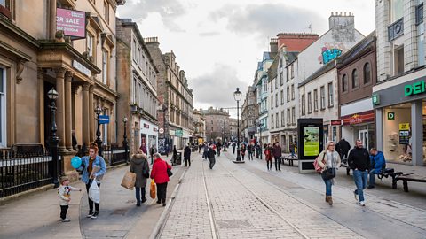 A photo of a shopping street in a town