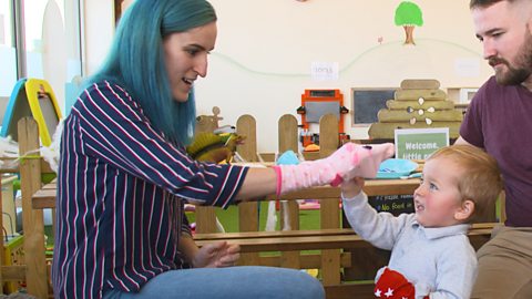 Mum and son playing sock puppets. 