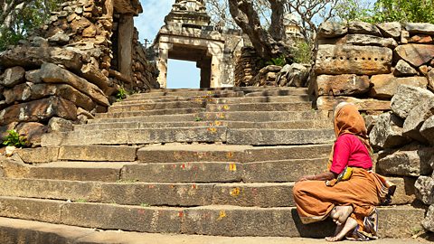 Hinduism  – An elderly woman begging at a temple in India