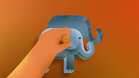 A child's hand placing an elephant-shaped puzzle piece in place.