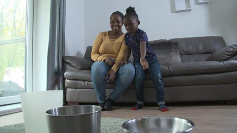 Mum and son sat on the sofa throwing socks.