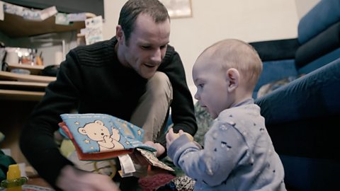 Dad reading to baby. 