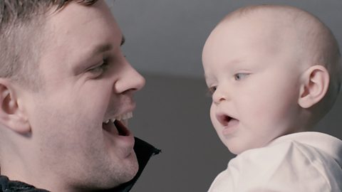 Dad and baby facing each other, close up.