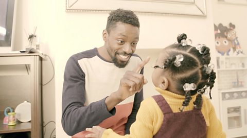 Dad touching his daughter's nose.