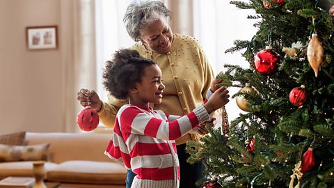 Decorating a Christmas tree.