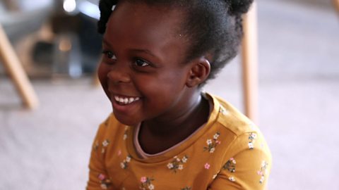 Close up of girl in yellow dress smiling