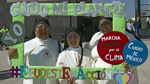 Christian nuns pose with a frame reading ‘I take care of my planet’ at the Global Climate March in Mexico City